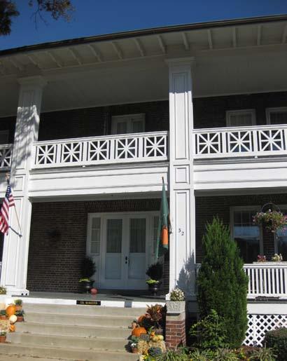 two-story, twolevel porch that covers the entire façade of the building.