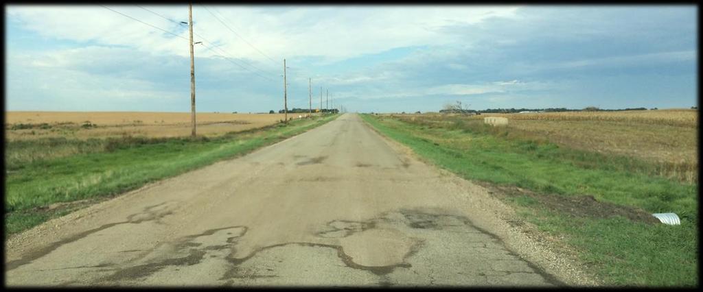 Figure 1-14: PASER Rating 4 PASER Rating 3: Very poor. Severe cracking and rutting with moderate visible potholes. Heavy patching with some patches on old patches. Limited striping.
