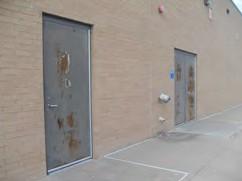 Rusty doors on south side of gym locker rooms.