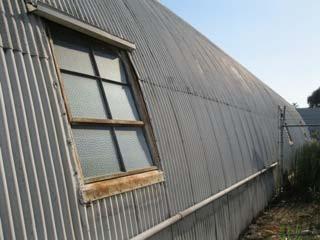 three quonset hut metal structures