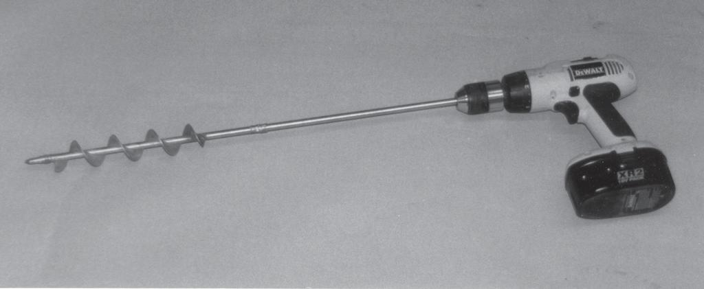 BATTERY-POWERED HAND DRILL WITH AUGER Description: The DeWalt 18-volt, battery-powered reversible drill (Figure 5) was used with augers to make planting holes.