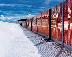 Constructed wind breaks or snow fences are typically made of slatted wood fences, wood, plastic webbing, or metal materials.