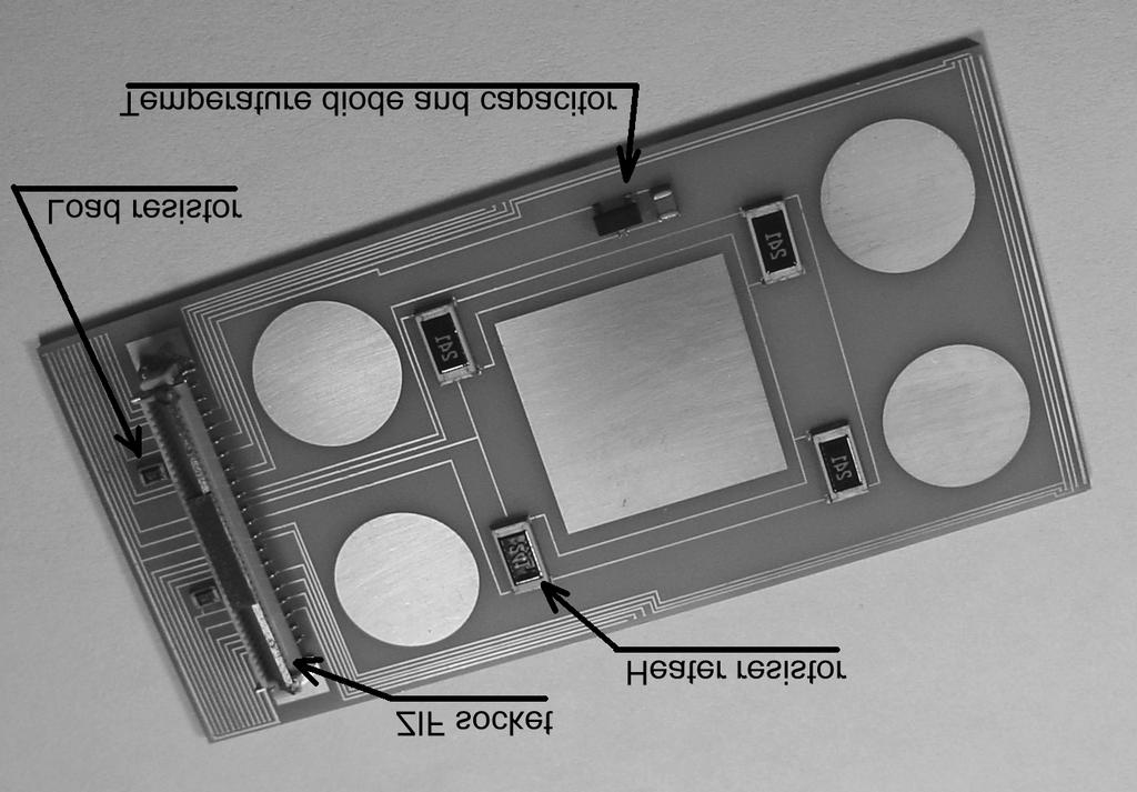 The middle two layers, glued to the patterned aluminum nitride, consist of three pieces of aluminum nitride which leave two slots. Into these slots are placed two rectangular nuts.