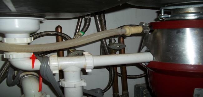 Local plumbing ordinances require the dishwasher discharge to be connected to a tailpiece not the waste disposal.