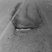 Cracking - Slippage Description Crescent or rounded cracks in the direction of