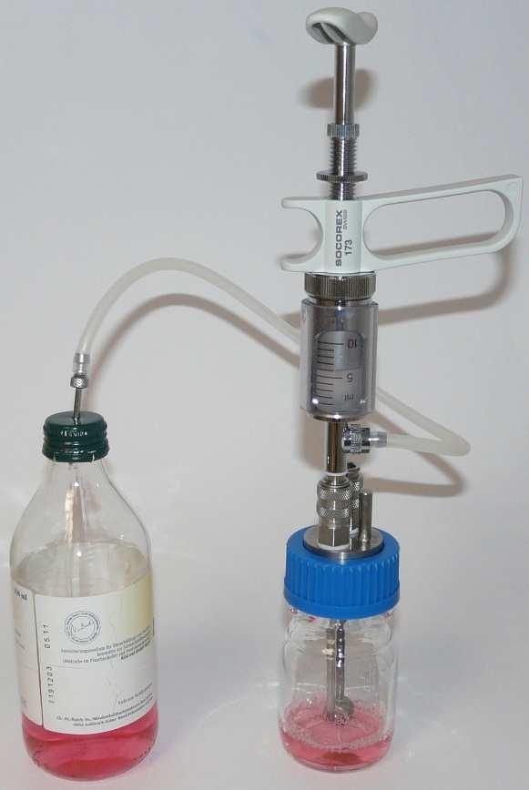 In the laboratory, the bottle is filled with a culture medium under sterile conditions without opening