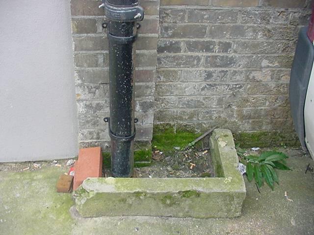 General view of flat roof Water getting into building Gutters and Downpipes: Cast iron and plastic gutters and downpipes Outlet