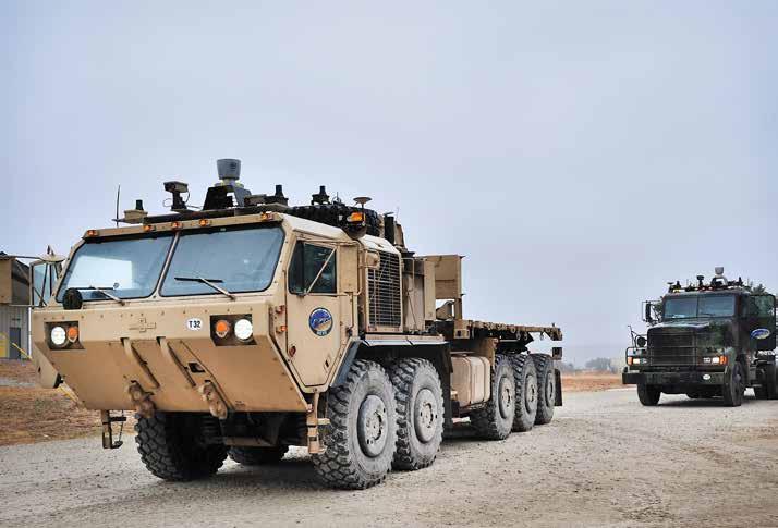 An M1075 palletized load system truck and an M915 line-haul tractor are equipped with add-on kits that transform the vehicles to be fully autonomous.