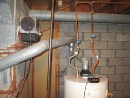 At the time of the inspection it was noted that the existing exhaust pipe orientation of the furnace and hot water tank is not installed in the correct format (where they enter the chimney).
