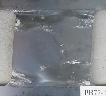 Significant cracks occurred at the corners of the panel due to fatigue under reversed cyclical loading.