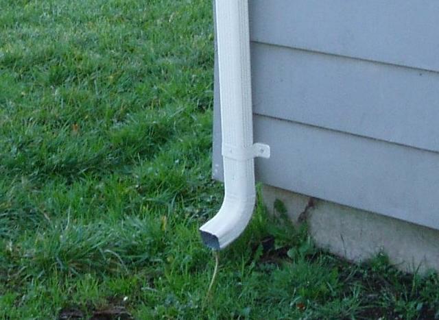 One or more downspouts drain too close to the home's foundation.