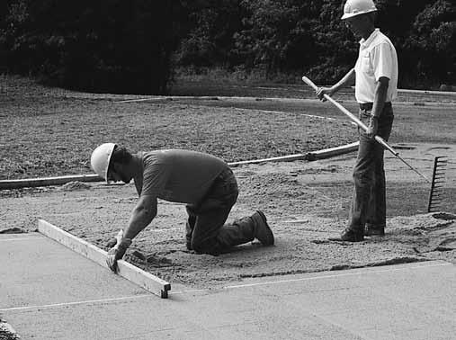 Figure 6. Screeding the bedding sand. Placing and Screeding the Bedding Sand Bedding sand under concrete pavers should conform to ASTM C 33 or CSA A23.1. This material is often called concrete sand.