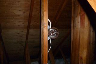 Recommend that a qualified professional put a wire nut on the hot wire and put a cover on the box, or finish the lighting circuit. Photo 12-1 Open box with hot wire in closet.