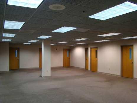 fluorescent lights, carpeted floors, and painted sheetrock