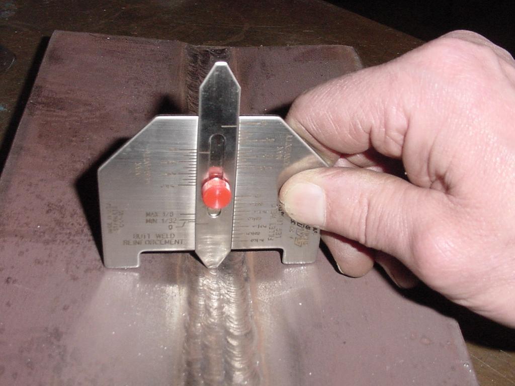 The weld gage is being used to measure weld reinforcement in this picture.