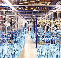 When a batch of garments has been loaded into carriers they are fed past a mechanical or electronic device which records the number of the carrier and addresses it to its