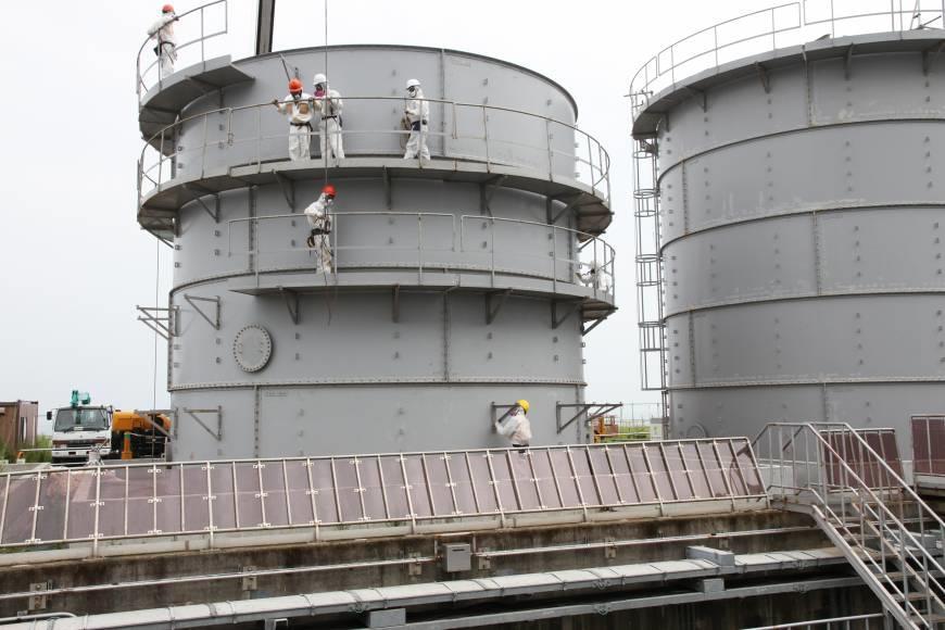(23 August 2013) Manning the parapets Workers are seen on storage tanks at the Fukushima Daiichi nuclear plant during the