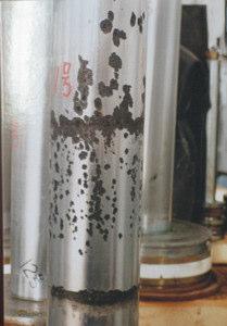 Fig. 2 (a) Worn and Corroded surface of the cylinder