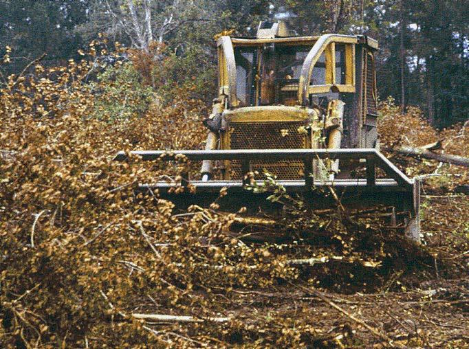 Figure 3. Once felled, debris is raked into piles or rows to complete the land-clearing operation. Figure 5.