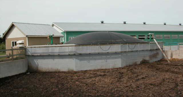 A floor of loose fitting wooden boards covered with loose fitting insulation separates the digester portion from the gas storage.