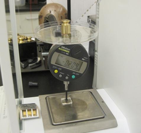 Figure 7. The instrument setup for macroscopic tests. In Figure 7, the force is measured by the scale under the sample, while displacement is measured by the gauge above the sample.