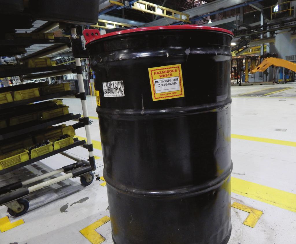 A container that holds aerosol cans waiting to be punctured should be managed as a hazardous waste storage drum.