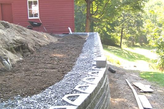 When compacting over the geogrid, work from near the retaining wall units toward the tail of the geogrid. This procedure helps keep the geogrid taught.