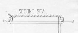 The second seal is formed by the union of the top edge of the container wall (Figure #3) and the inside wall of the lid.