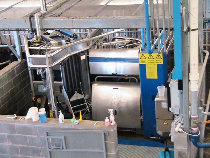 Figure 6.13: Robotic milking machine. Identify advantages and disadvantages associated with a robotic milking system. Check your answer.