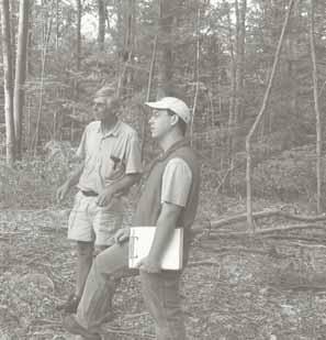 A public forester discusses land conservation options with a landowner.
