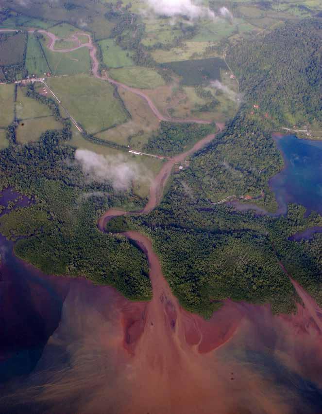 A river carrying a heavy sediment load empties into the ocean on the Costa Rican coast.