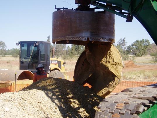 As the formation is cut, the cuttings accumulate on the auger flights, and they are removed from the hole by withdrawing the auger to the surface and spinning it to dislodge the cuttings.