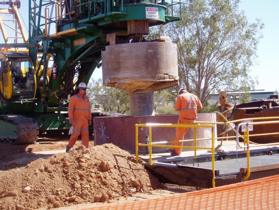 Rotary drilling can either remove spoil to the surface using conventional drill buckets or can allow spoil to bottom drop through pilot holes into adits or drives below for later removal.