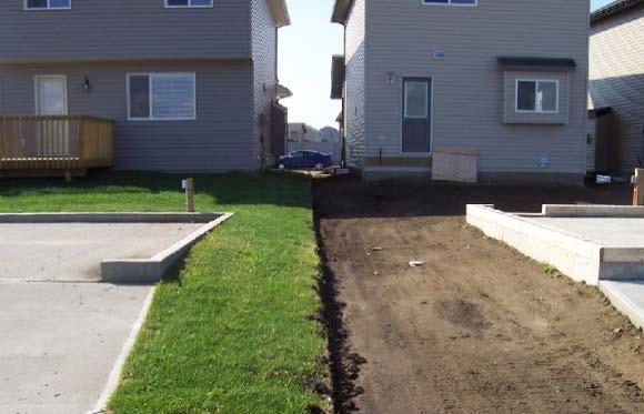 The garage pad elevation provides slope away from the building An internal swale is configured between the detached garage and the house Pads have been built with retaining walls for
