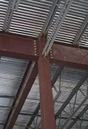 " The top flange of the beam is coped to match the girder elevation.