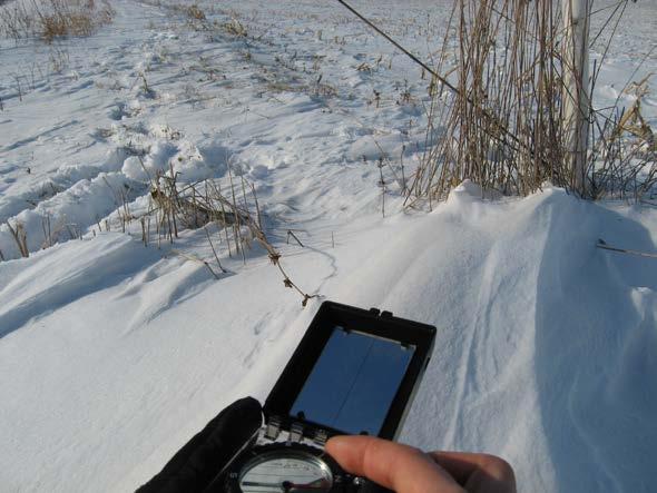 Figure A-1 Field-based method for determining direction of prevailing snow transport by measuring streamlined snowdrift orientation using a compass.
