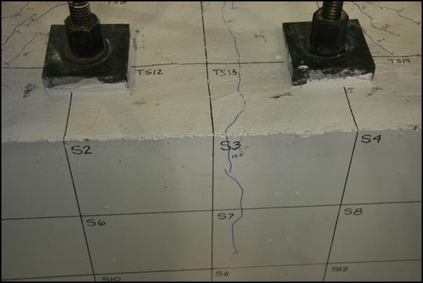 During the 13 th cycle level, a crack propagated radially from the column down the South face of the cap beam, as shown in Figure 5.24.