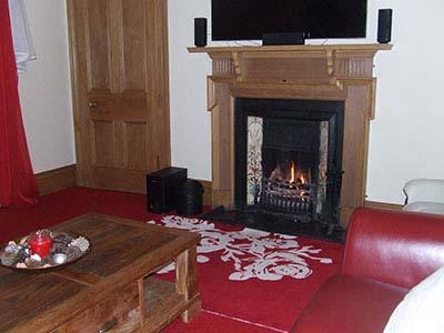 timber fire surround with tiled rear and hearth with coal fire; television point;
