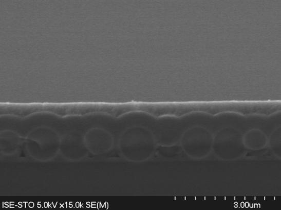 Figure 4: SEM cross section of a hexagonal monolayer of SiO 2 -spheres with a diameter of 922 nm. Due to the conformal TiO 2 -deposition a structured surface remains after the inversion process.