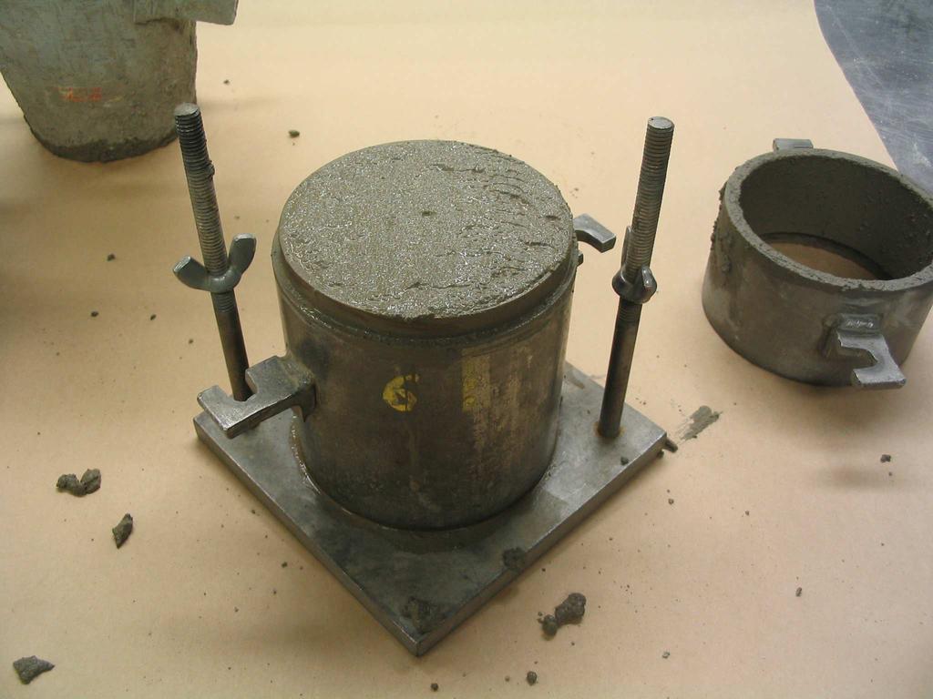 A large plastic cylinder was placed on the top of the fresh concrete sample.