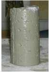 As shown in Figure 4, in the modified test, a 4x8 inch cylinder was loosely filled up with fresh concrete. This cylinder was then placed on the drop table and subjected to 25 drops.