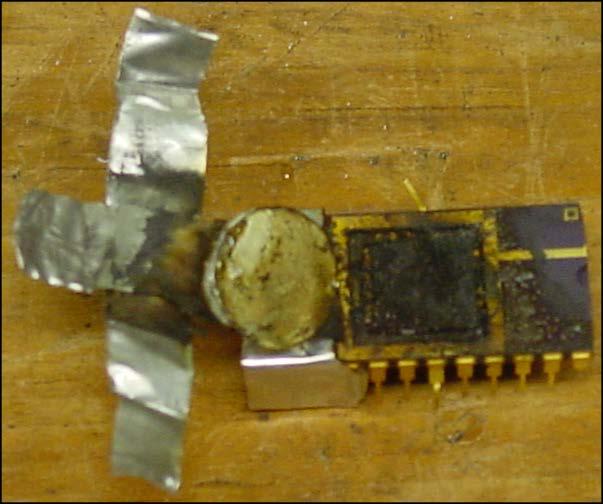 Figure 16. Photograph of CuO nanothermite reaction residue on chip and minimal JA2 disk residue after ignition. 4.