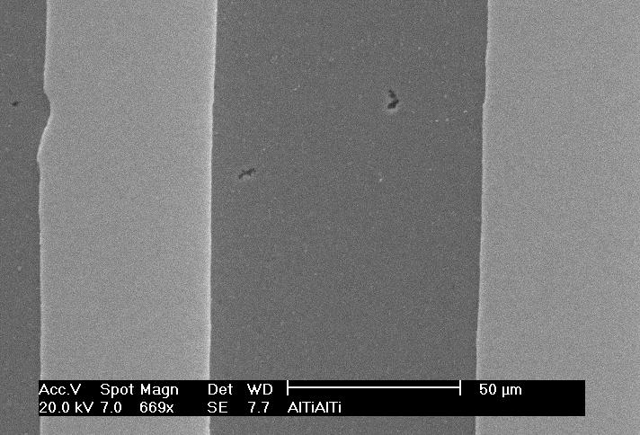 Ti Al laminate produced via UC at lower and higher magnification.