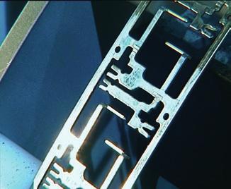 Fig. 11. The prepared metal strip is unwound from the coil and fed to the stamping die in the automation cell (photo: Neureder) Maffei represent a good foundation for technological advancement.