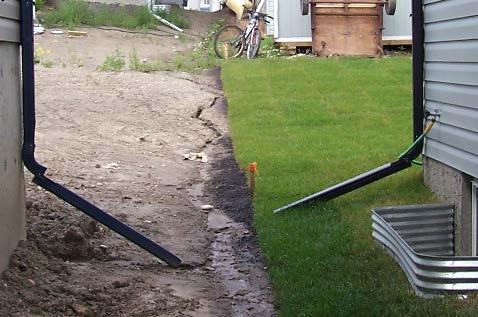 downspouts draining onto soft landscaping (sod, topsoil or mulch).