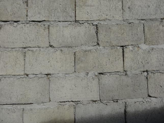 Figure 75. Poor masonry work on Bohol. Note the absence of mortar in the vertical joints. Figure 76. Inadequate masonry wall connections on Bohol.