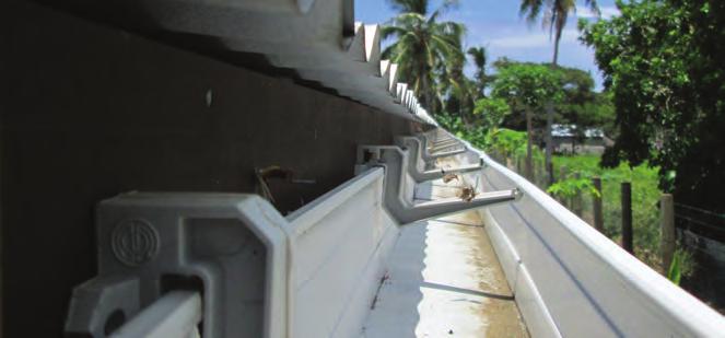 Clean out gutter channel at least once a month, diverting wash water away from storage tank. Install a first-flush device on down pipes.