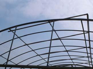 One is for controlling the arch roof and the other is for raising and lowering the side walls (Fig. 8). Figure 9 shows the plastic film of the inner structure fully rolled up on the arch roof.