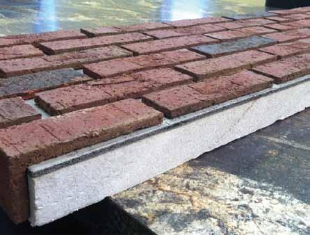 mortaring: When all applied panels are secured in place with caulking and flashing complete, fill in all bed and head joints with mortar.