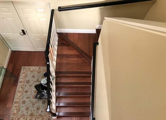 Stair safety: Small riser bars that were added under the treads close the space between to less than 4 and the guardrail was installed between stringers remove fall risk.